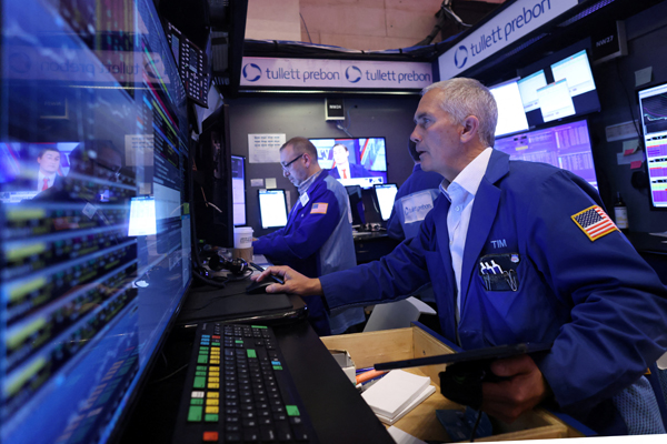 Traders work on the trading floor at the New York Stock Exchange (NYSE) in New York City, U.S., April 4, 2024. REUTERS/Andrew Kelly